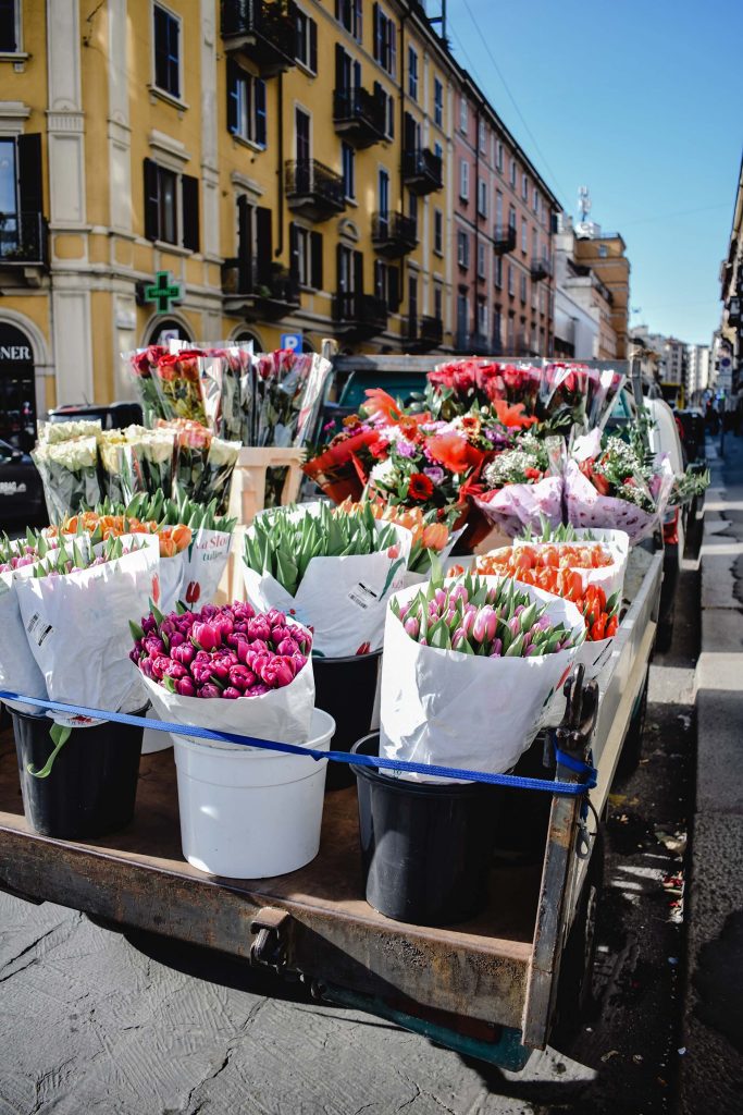 flowers on the back of a truck, european street